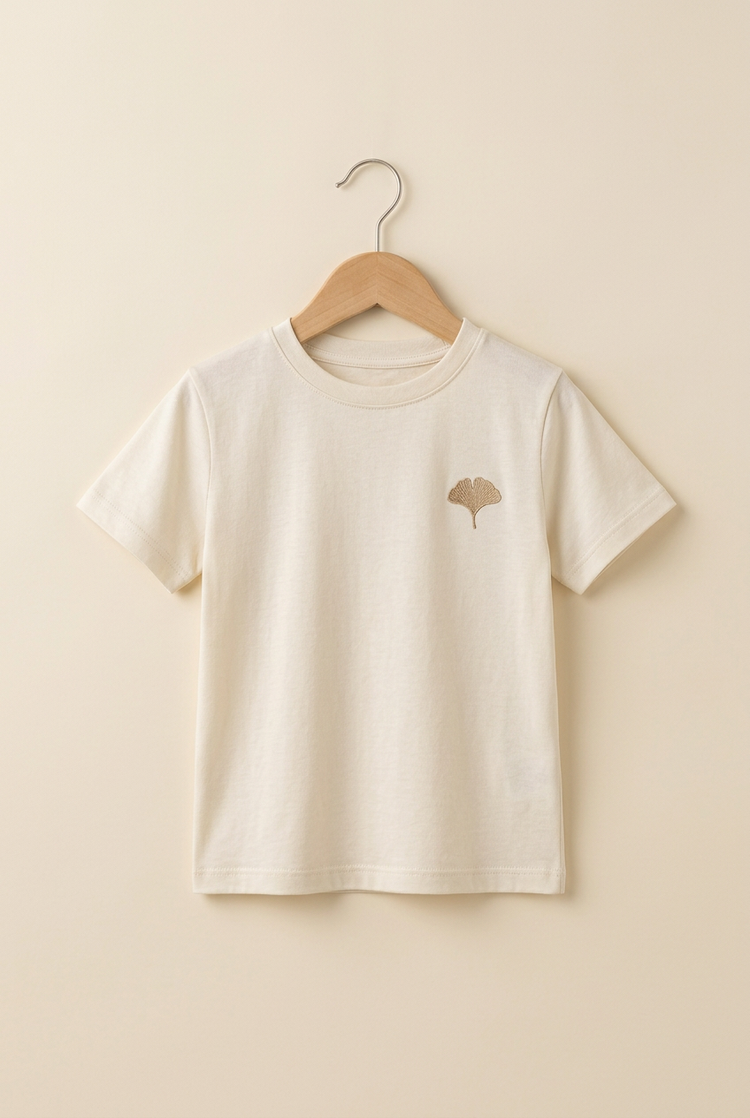 Minimal Luxury junior tee in ivory, front on hanger