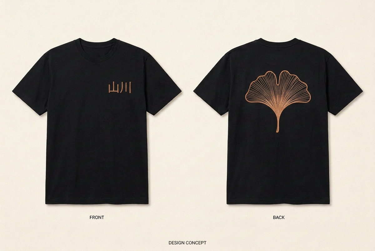 Design preview of the black Ginkgo Club Tee: small copper-coloured Japanese lettering on the front and a large copper-coloured ginkgo leaf on the back.