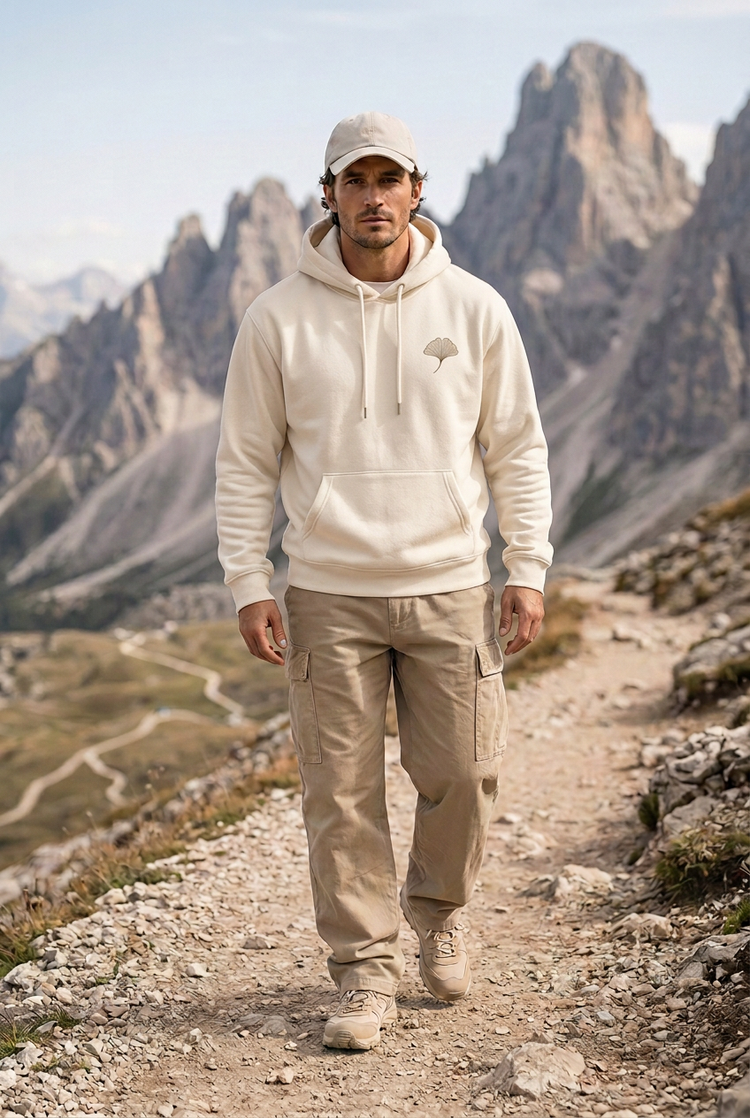 Herick & Belle Outdoor Balance ivory hoodie worn by male model on mountain path