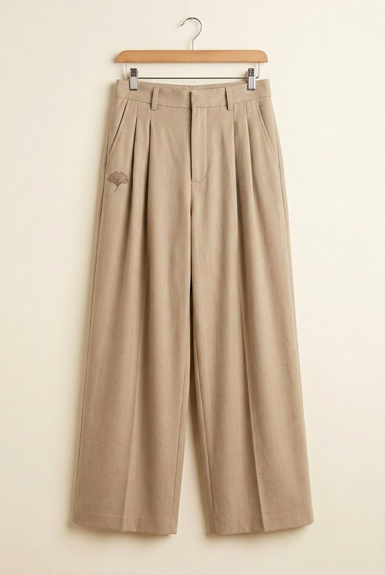 Herick & Belle Layering Style sand trousers, front with ginkgo on wearer's right leg
