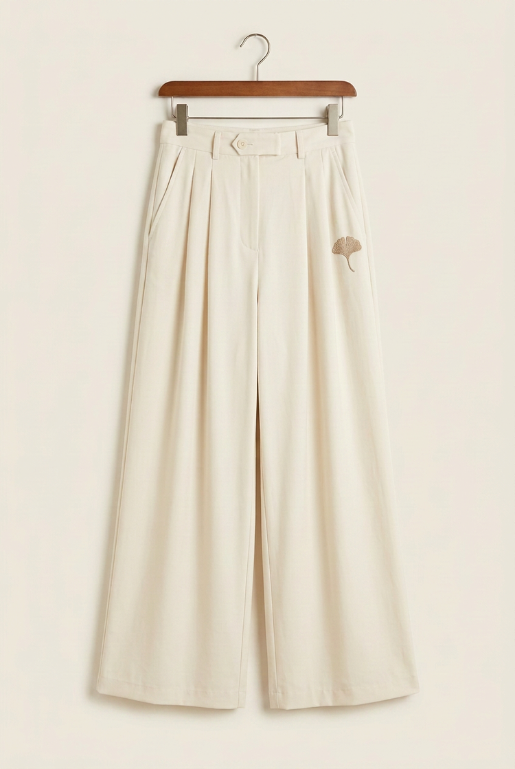 Minimal Luxury ivory pleated palazzo ginkgo trousers on hanger, front