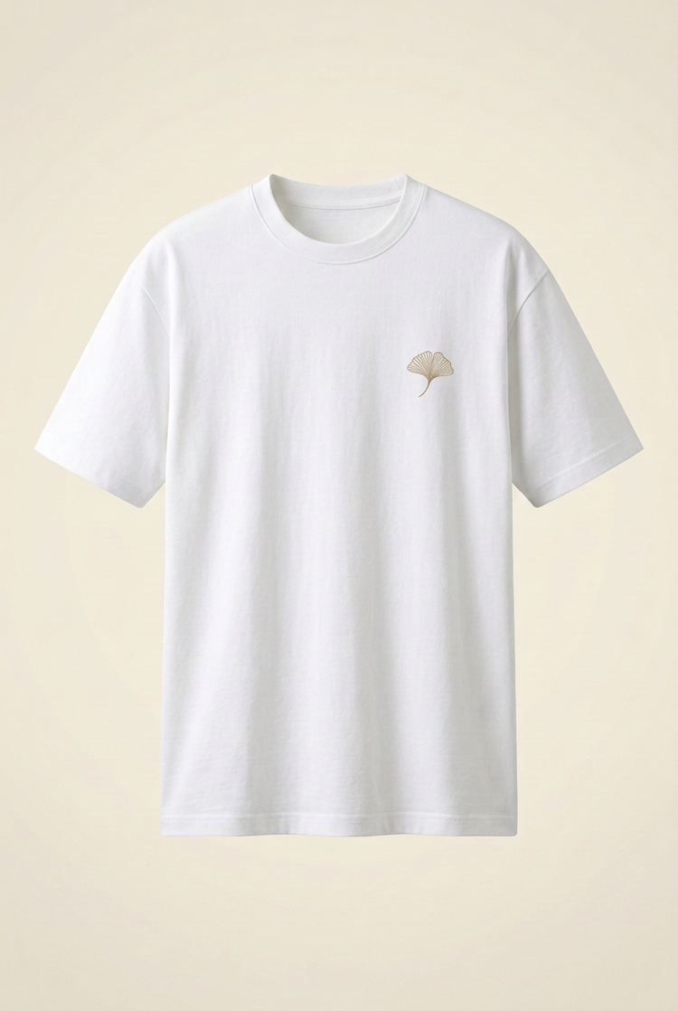 White SANSEN T-shirt front with small sand-toned ginkgo embroidery on the left chest