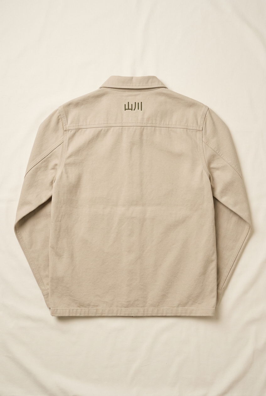 Sand SANSEN men's chore jacket, back with small 山川 embroidery below the collar